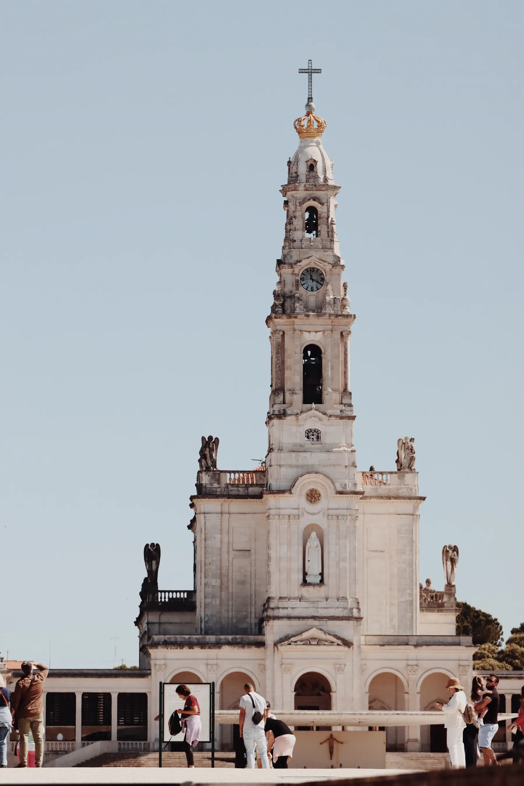 Pilgrims and church tower at the Sanctuary of Fátima, Portugal