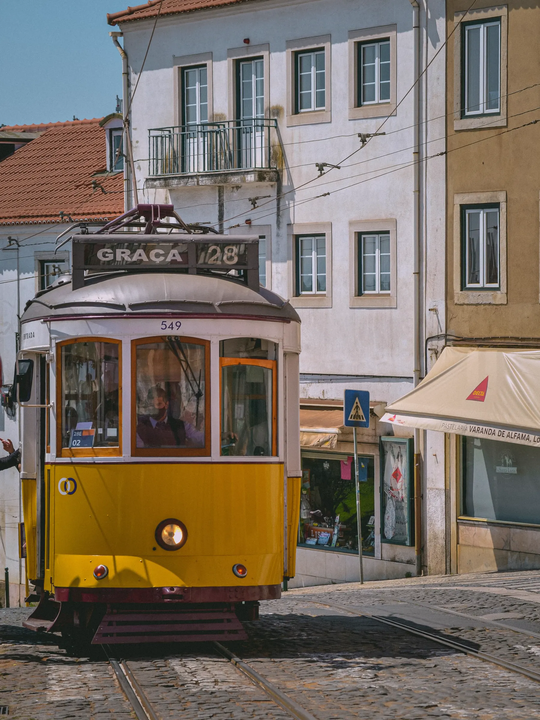Traditional yellow tram on a street in Lisbon, Portugal